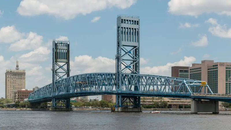 The blue Main Street Bridge over the St. Johns River with the Jacksonville skyline