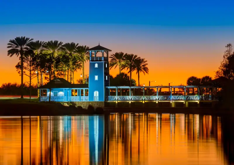 Lake Tradition at twilight, with a lit tower reflected in the water